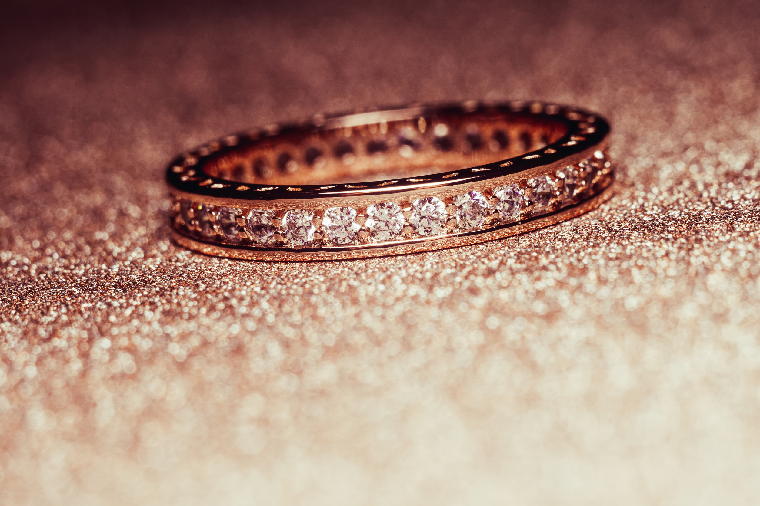 Fashion golden ring over glittering background, macro, vintage effect.