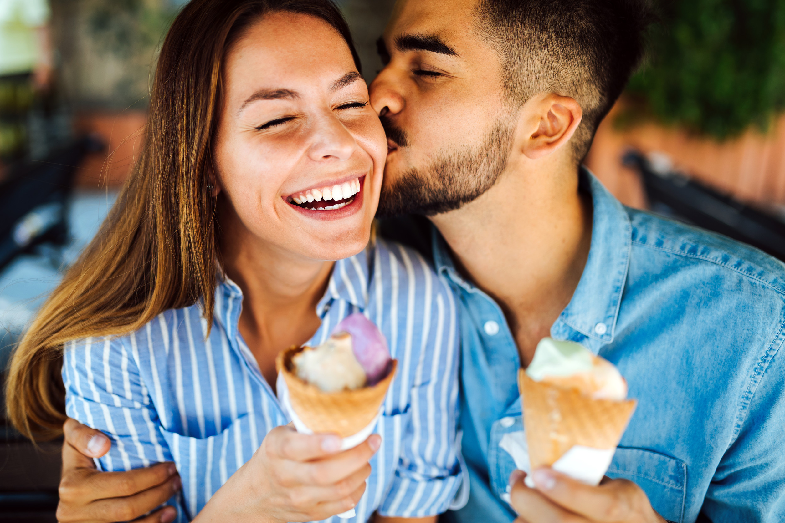 Happy young couple having date and eating ice cream