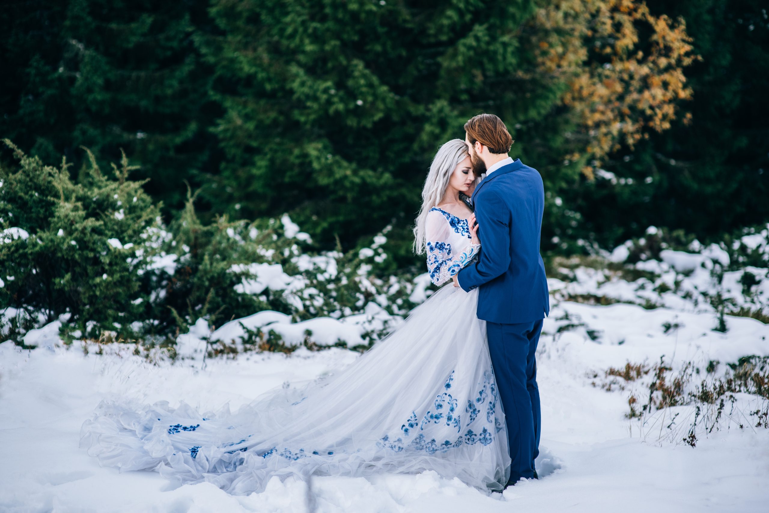 groom in a blue suit and bride in white in the mountains Carpath