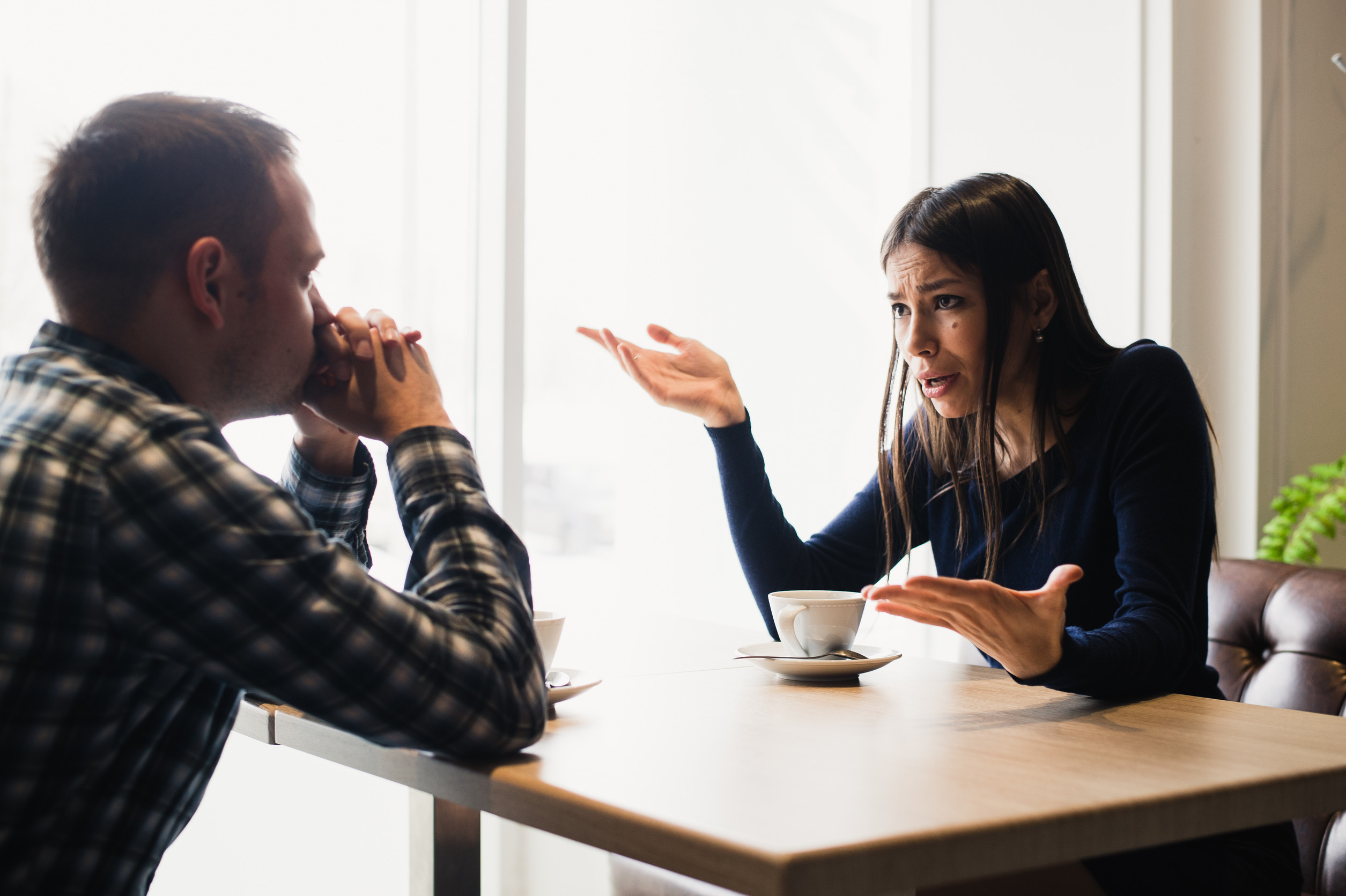 Young couple arguing in a cafe. Relationship problems