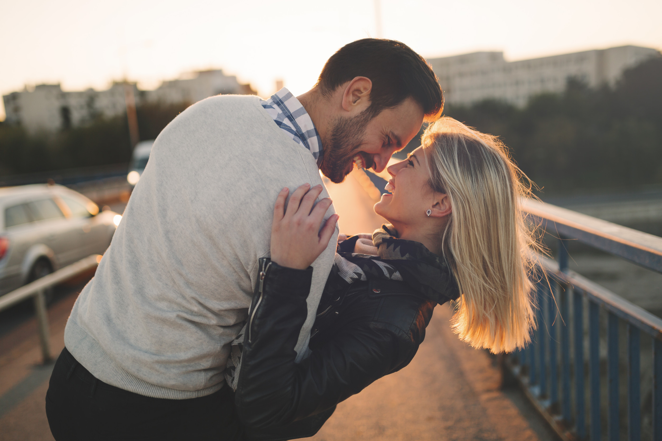 Romantic couple in love enjoying sunset and kissing