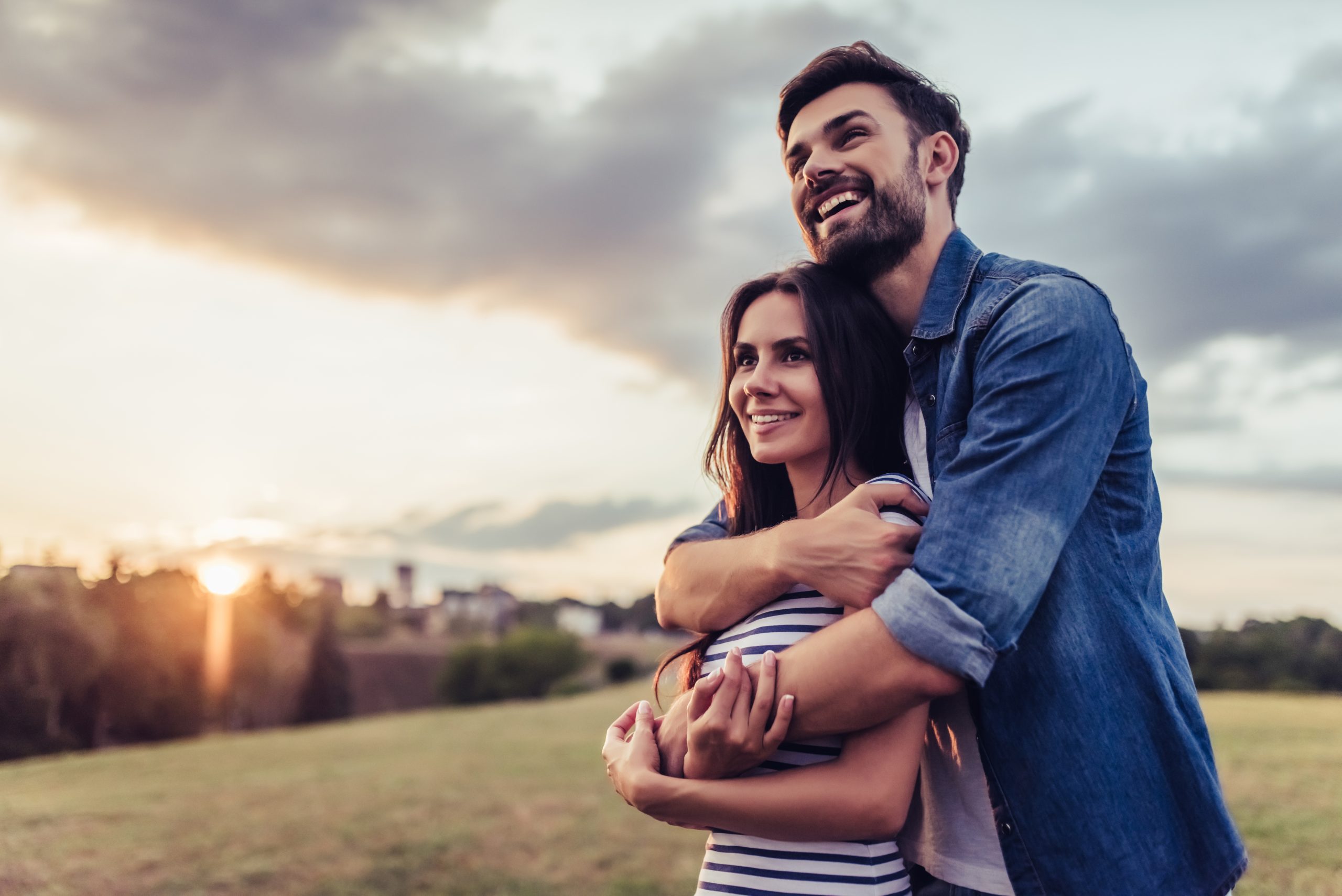 Beautiful romantic couple enjoying the company of each other outdoors. Feeling tenderness and comfort while being together.