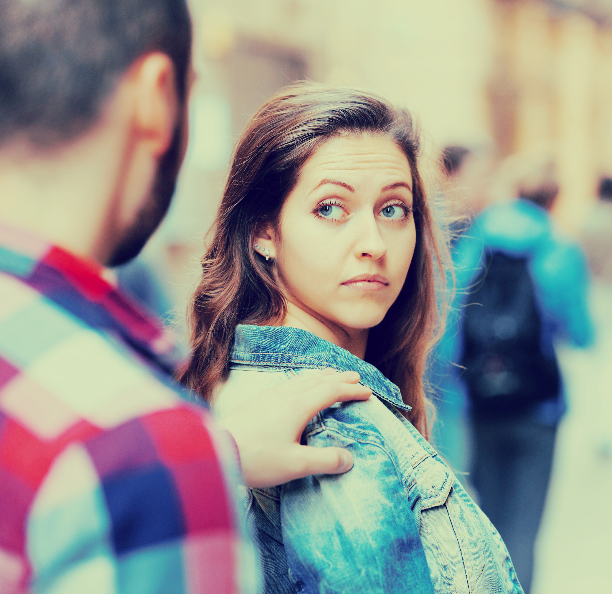 Boring male person accosting to young girl at crowded street