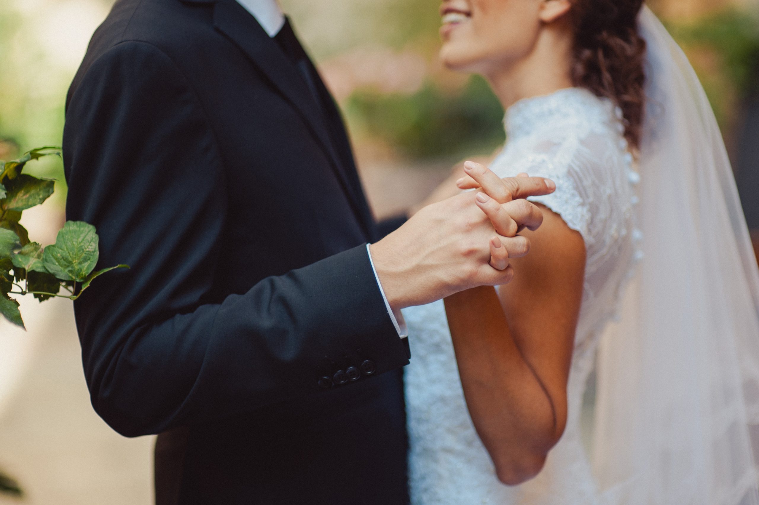 Holding hands. Closeup view of married couple holding hands