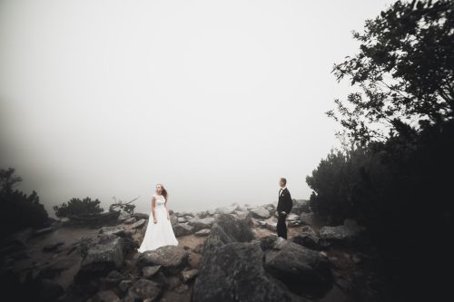 Perfect couple bride, groom posing and kissing in their wedding day.